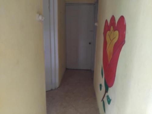 a room with a surfboard with a painting on the wall at Yvonne's House in Kingston