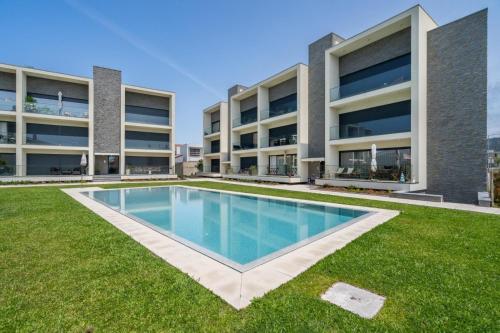 an image of an apartment building with a swimming pool at Praia Mar Apartamento T2 in Esposende