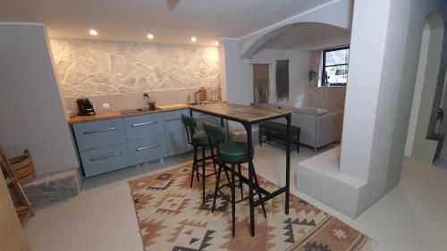 a kitchen with a table and stools in a room at City Souterrain Nijmegen in Nijmegen