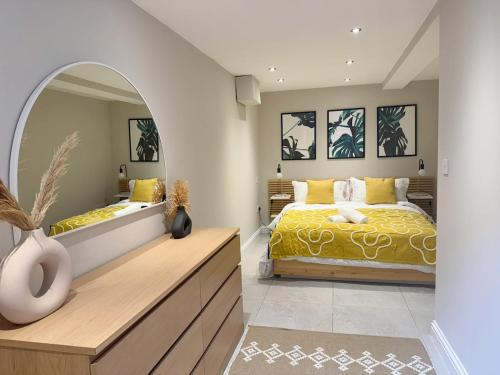 a bedroom with a bed and a large mirror at Central Bury Apartment with Private Entrance in Bury Saint Edmunds