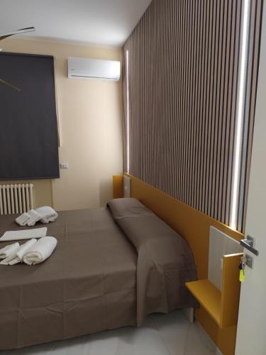 a bedroom with a bed with two towels on it at L Oasi di Lauria in Lauria