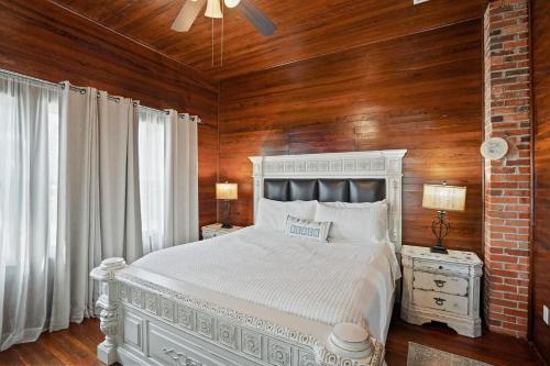 a bedroom with a white bed and wooden walls at Ivey House by Coastline Vacation Rentals in Saint Joe Beach