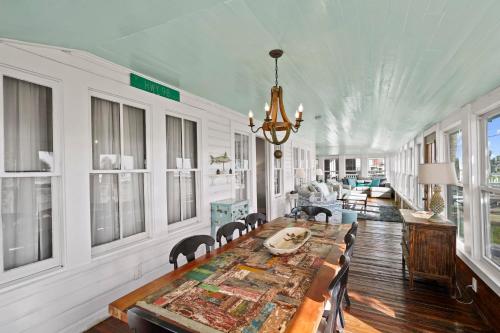 a dining room with a long table and chairs at Ivey House by Coastline Vacation Rentals in Saint Joe Beach