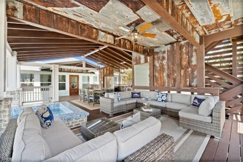 an open living room with white furniture and a wooden ceiling at Ivey House by Coastline Vacation Rentals in Saint Joe Beach