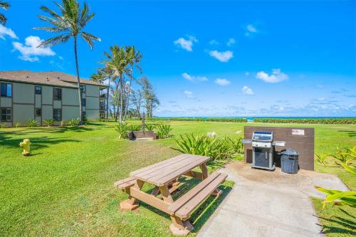 a picnic table and a grill in a yard at Condos in Kapaa in Kapaa