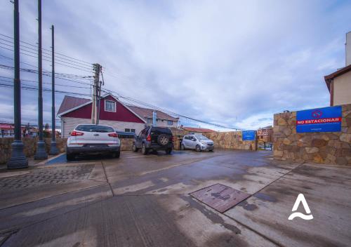 a parking lot with cars parked next to a building at Almasur Express Punta Arenas in Punta Arenas