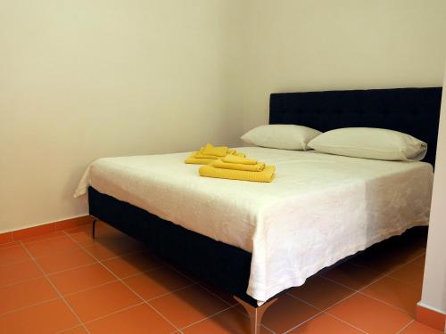 a bed with yellow towels on top of it at Nonna Anna Rooms in Cetara