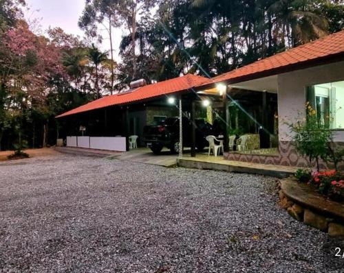 a house with a car parked outside of it at Refúgio Sereno in Nova Friburgo