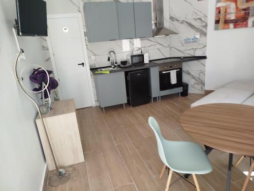 a small kitchen with a table and a dining room at Bungalow feliz acepto mascotas in Torrevieja