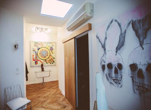 a hallway with a room with a skull on the wall at La terrasse de la comédie in Montpellier