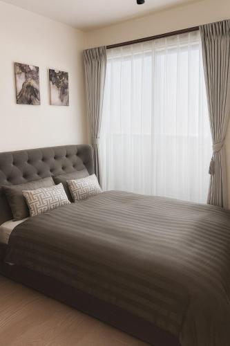 a bedroom with a large bed with a large window at sunshin dream in Osaka
