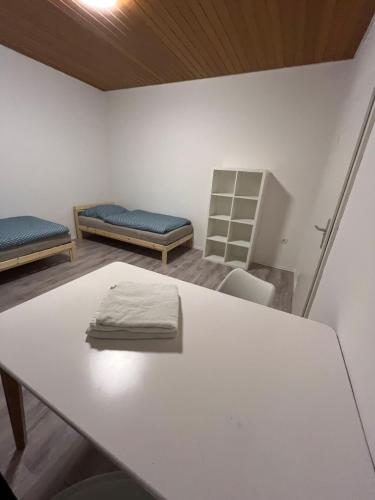 a room with two beds and a table at Ferienwohnung Monteuerzimmer Melle in Melle