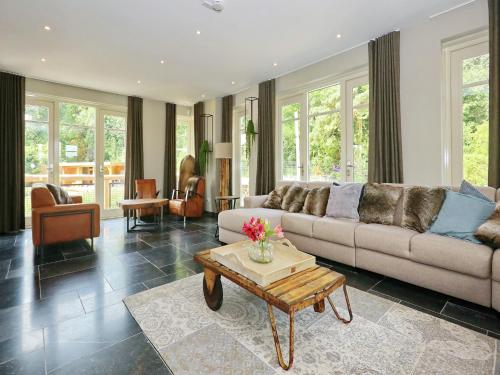 a living room with a couch and a table at Holiday Home with bubble bath in Noordwijk in Noordwijk