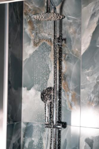 a shower with water pouring out of it at Porto & Mare Elegant Suites in Diakopto