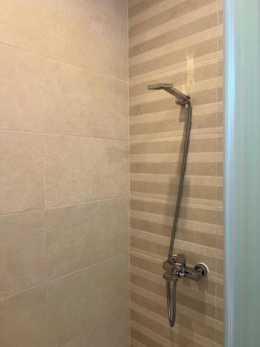 a shower with a shower head in a bathroom at Résidence 7 vagues in Oualidia