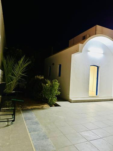 a building with a window and a patio at night at Villa Soltana in Zarzis