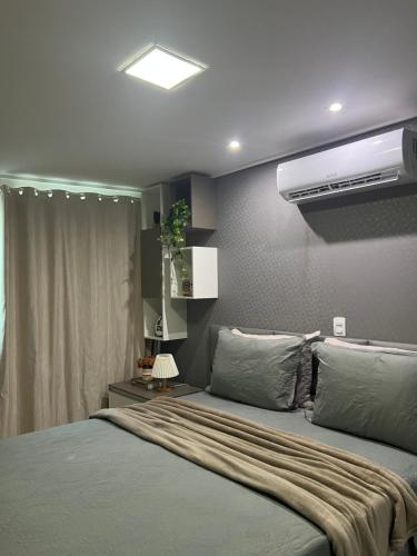 a bedroom with a large bed and a air conditioner at APART HOTEL MANAÍRA PALACE in João Pessoa