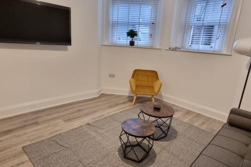a living room with a couch and a chair at Tower House Apartments in Wakefield