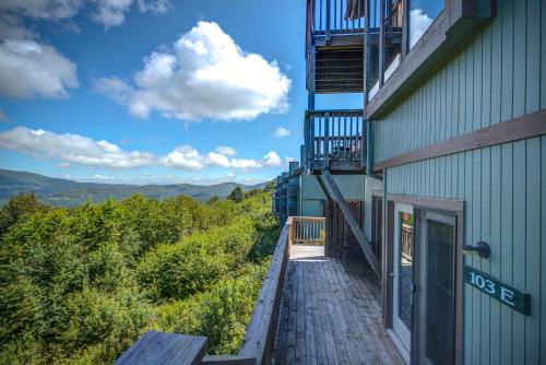 a building with a wooden walkway next to a balcony at The Highlands at Sugar in Banner Elk
