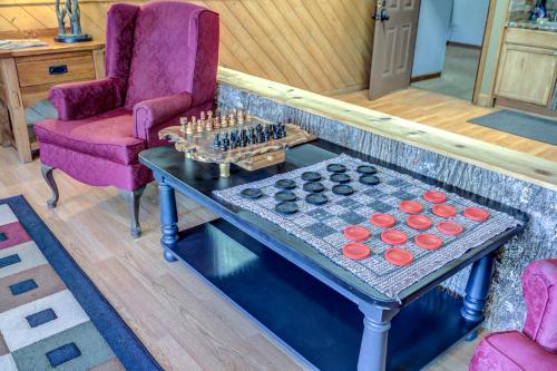 a living room with a table with a chessboard on it at The Highlands at Sugar in Banner Elk