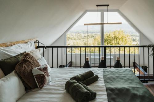 a bedroom with a large bed with a large window at Magyarmáli Pihenőház Verőce in Verőce