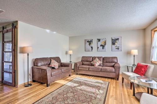 a living room with two couches and a table at Rapid City Home - Walk to Canyon Lake Park in Rapid City