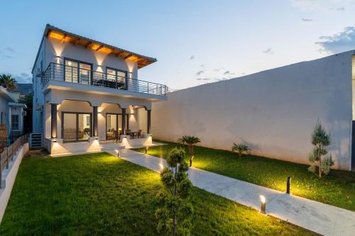 an image of a house with a yard at Porto & Mare Elegant Suites in Diakopto