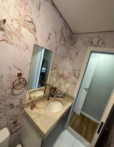 a bathroom with a sink and a mirror at High Standard coral beach in Santa Cruz Cabrália