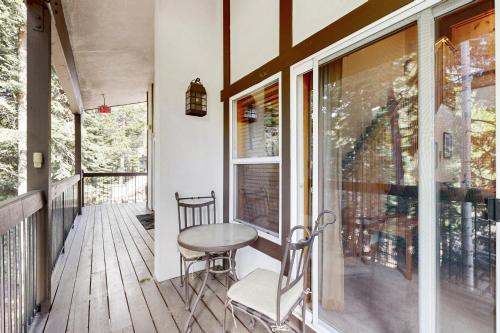 a porch with a table and chairs on a deck at Tavern Inn #55 in Olympic Valley