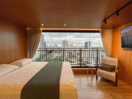 a bedroom with a bed and a large window at Luxury Collection - The Frame in Campo Grande