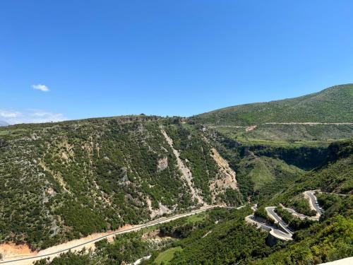 an aerial view of a mountain with a road at Vjosa Balcony Villa in Tepelenë