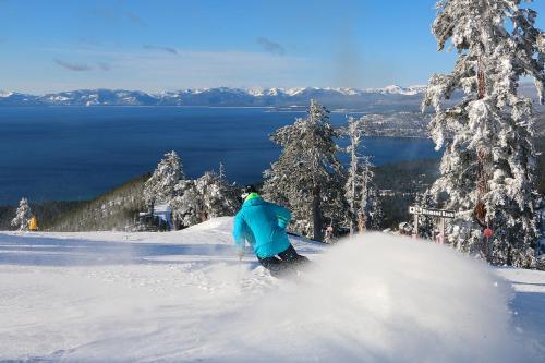 a person is skiing down a snow covered slope at Creekside Retreat in Incline Village