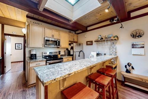 a kitchen with wooden cabinets and a large counter top at Creekside Retreat in Incline Village