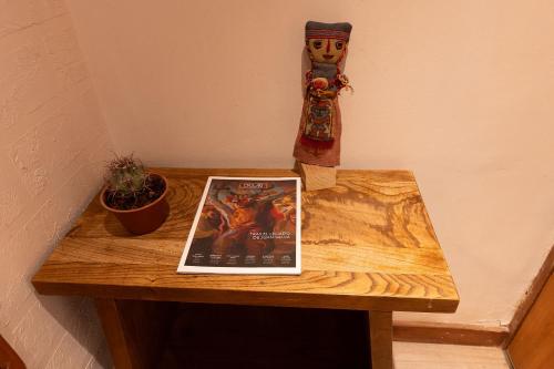 a table with a laptop computer on top of it at Hotel Don Raul in San Pedro de Atacama