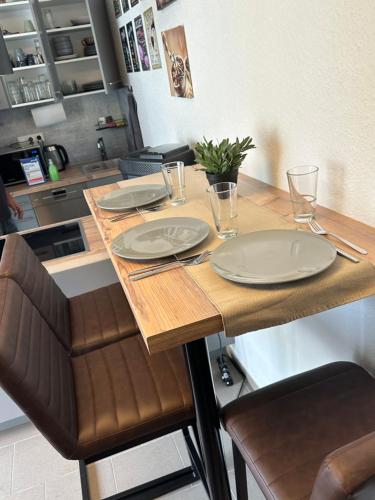 a kitchen with a table with plates on it at Ferienwohnung am Hoeschplatz in Düren - Eifel