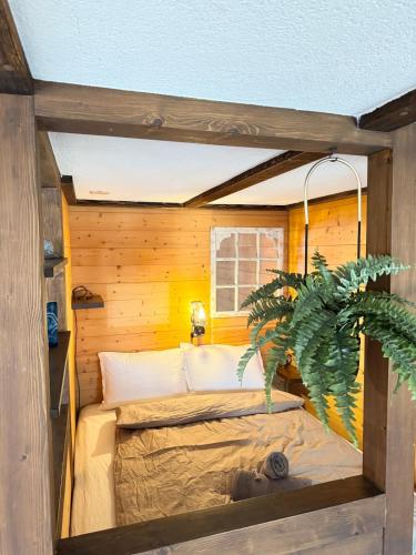 a small bedroom with a bed in a wooden wall at Chalet Idylle - mountain view & next to Interlaken in Ringgenberg
