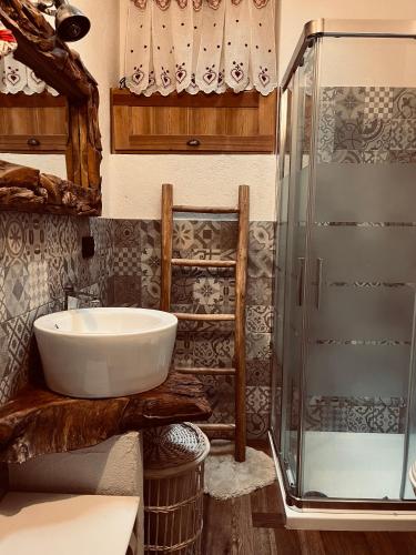 a bathroom with a sink and a shower at Chalet Lumière Alpine in La Salle