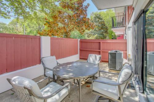 a patio with a table and chairs and a fence at Charming Myrtle Beach Townhome Walk to Beach in Myrtle Beach