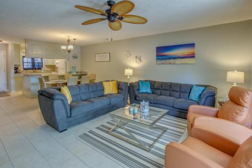 a living room with a blue couch and a table at Charming Myrtle Beach Townhome Walk to Beach in Myrtle Beach