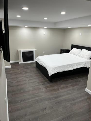 a bedroom with a bed and a flat screen tv at Cozy Modern Condo in East Orange