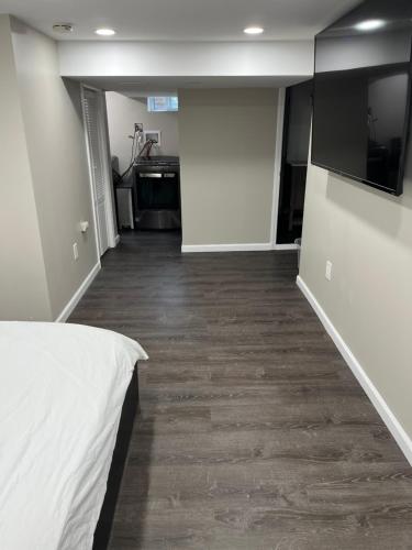 an empty room with a bed and a hallway at Cozy Modern Condo in East Orange