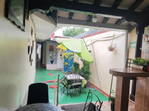 an outdoor patio with a table and an umbrella at Hostal Ruinas de San Sebastián in León