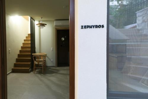 a hallway with stairs and a door with a sign on it at Maistros Deluxe Apartments in Ierissos