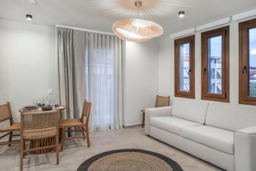 a living room with a couch and a table at Maistros Deluxe Apartments in Ierissos