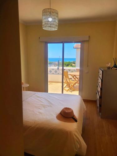 a bedroom with a bed with a hat on it at Porto Santo Rentals in Porto Santo