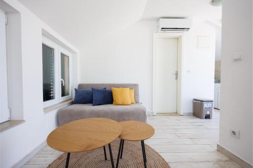 a living room with a couch and a table at Karantanovi Dvori in Murter