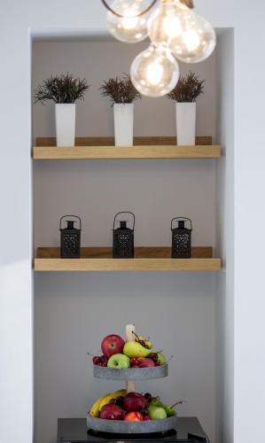 a bowl of fruit on a table with a light at Margaret of Naxos in Agios Prokopios