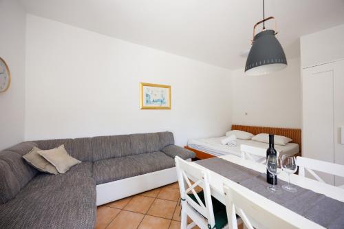 a living room with a couch and a table at Karantanovi Dvori in Murter