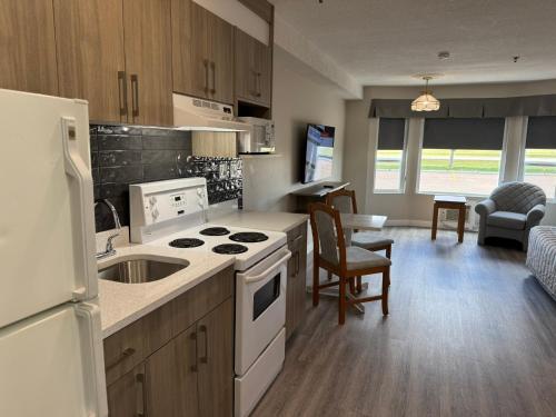 a kitchen with a sink and a stove top oven at Western Budget Motel Leduc #3 in Leduc