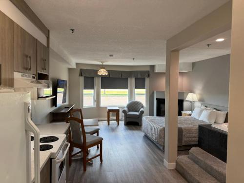 a hotel room with a bed and a kitchen at Western Budget Motel Leduc #3 in Leduc